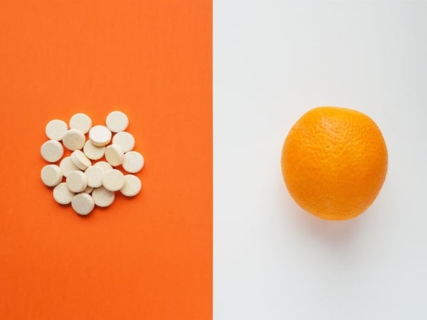 Some treatment medication and orange on a desk