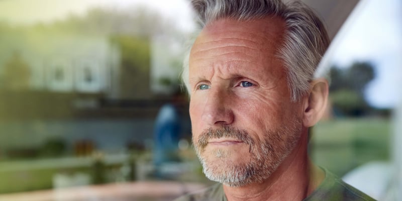 A man with low testosterone standing and looking tired